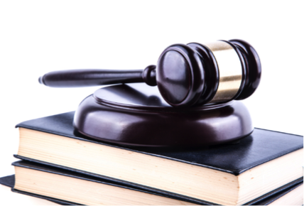 Mazo de tribunal sobre su base y dos libros.